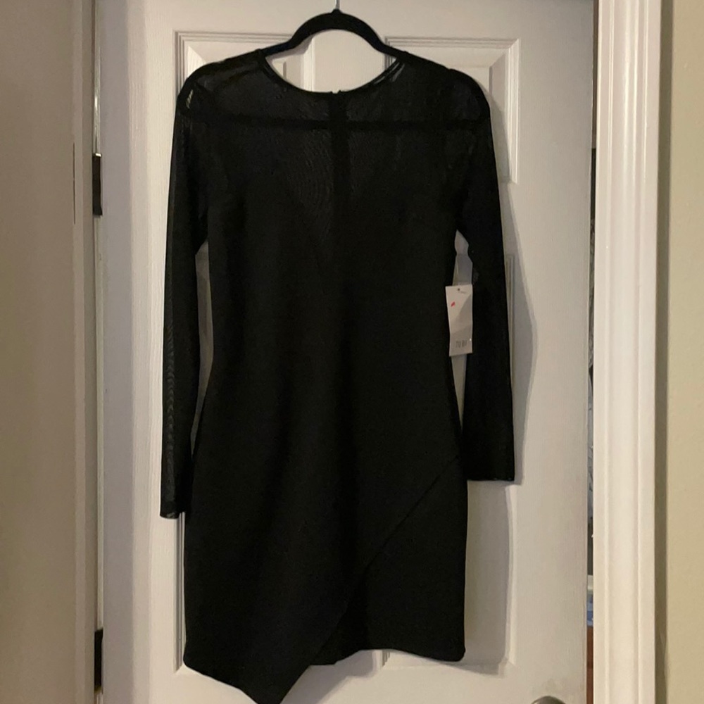 New with tags Toni long sleeve black dress. Netting throughout chest and arms.